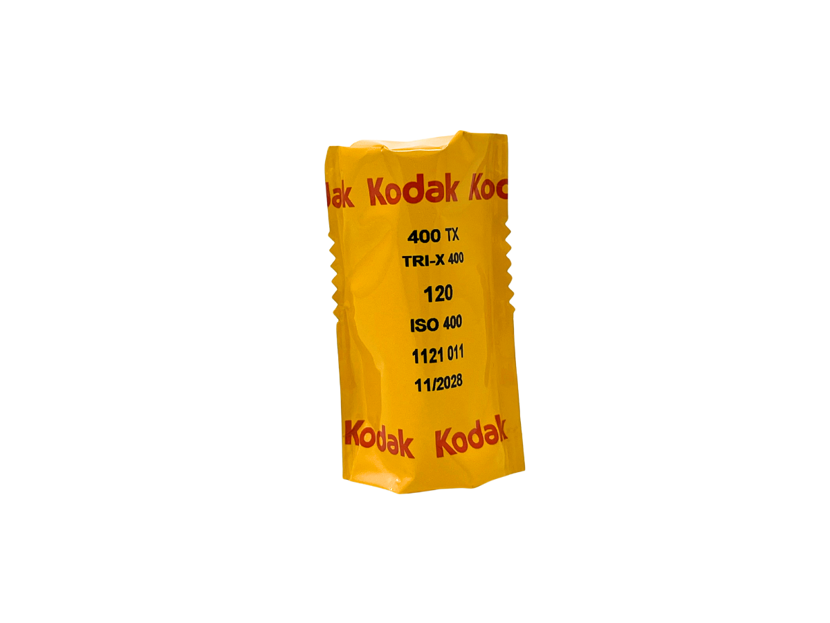A yellow Kodak Tri-X 400 film canister with red and black text, isolated on a white background.