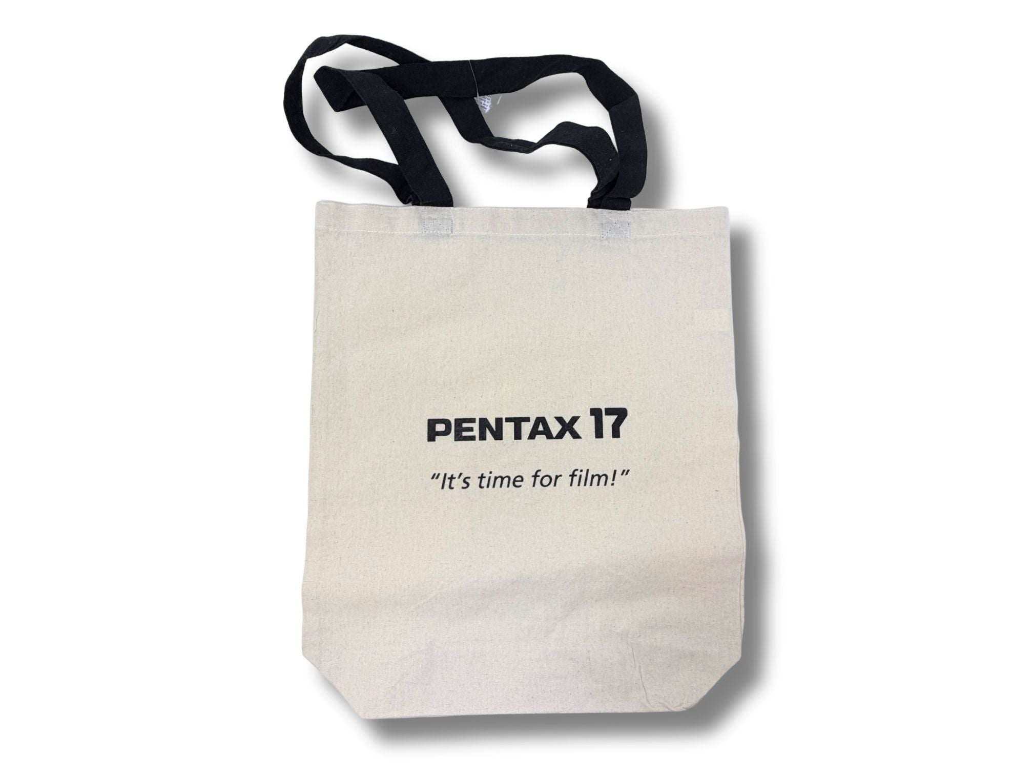 Canvas tote bag with Pentax branding, black handle and "It's time for film!" text on a white background.