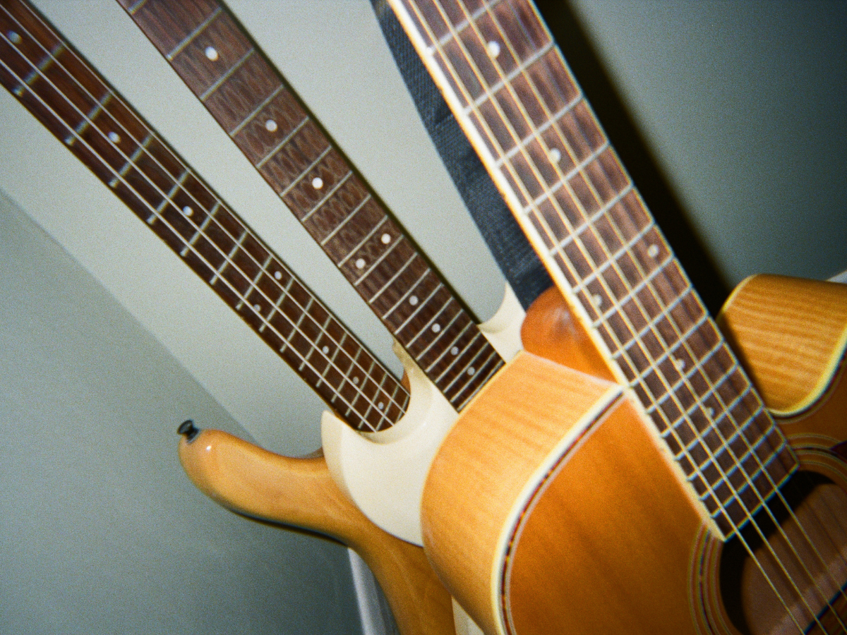 Close-up of two acoustic guitars with a neutral background - shot on PURE 35 film camera
