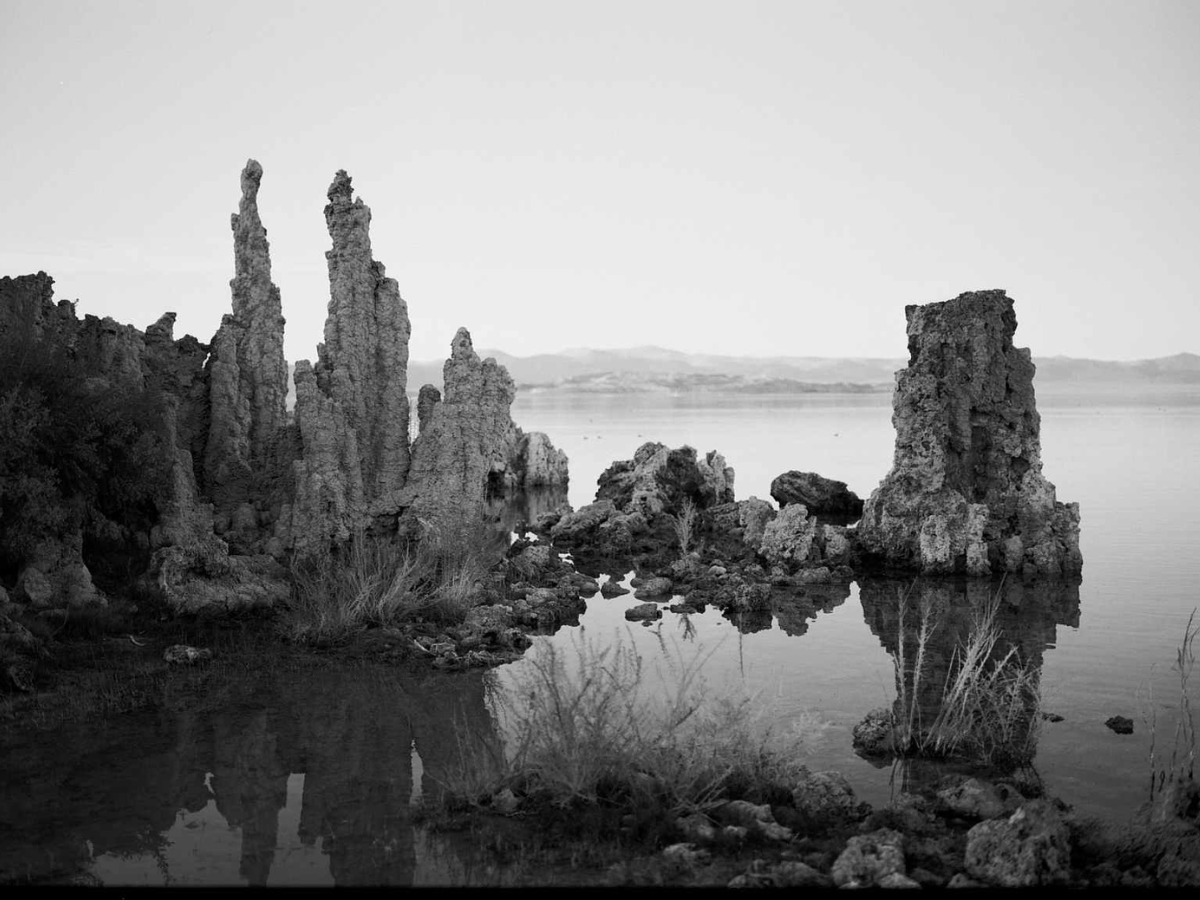 Tufa formations in a lake with a reflective surface