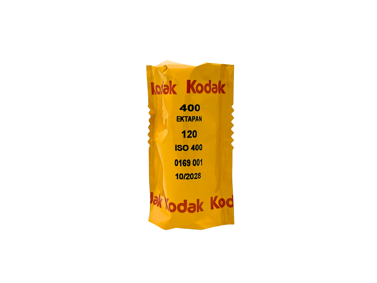 A yellow Kodak 400 Ektapan 120 film canister with red and black text, isolated on a white background.