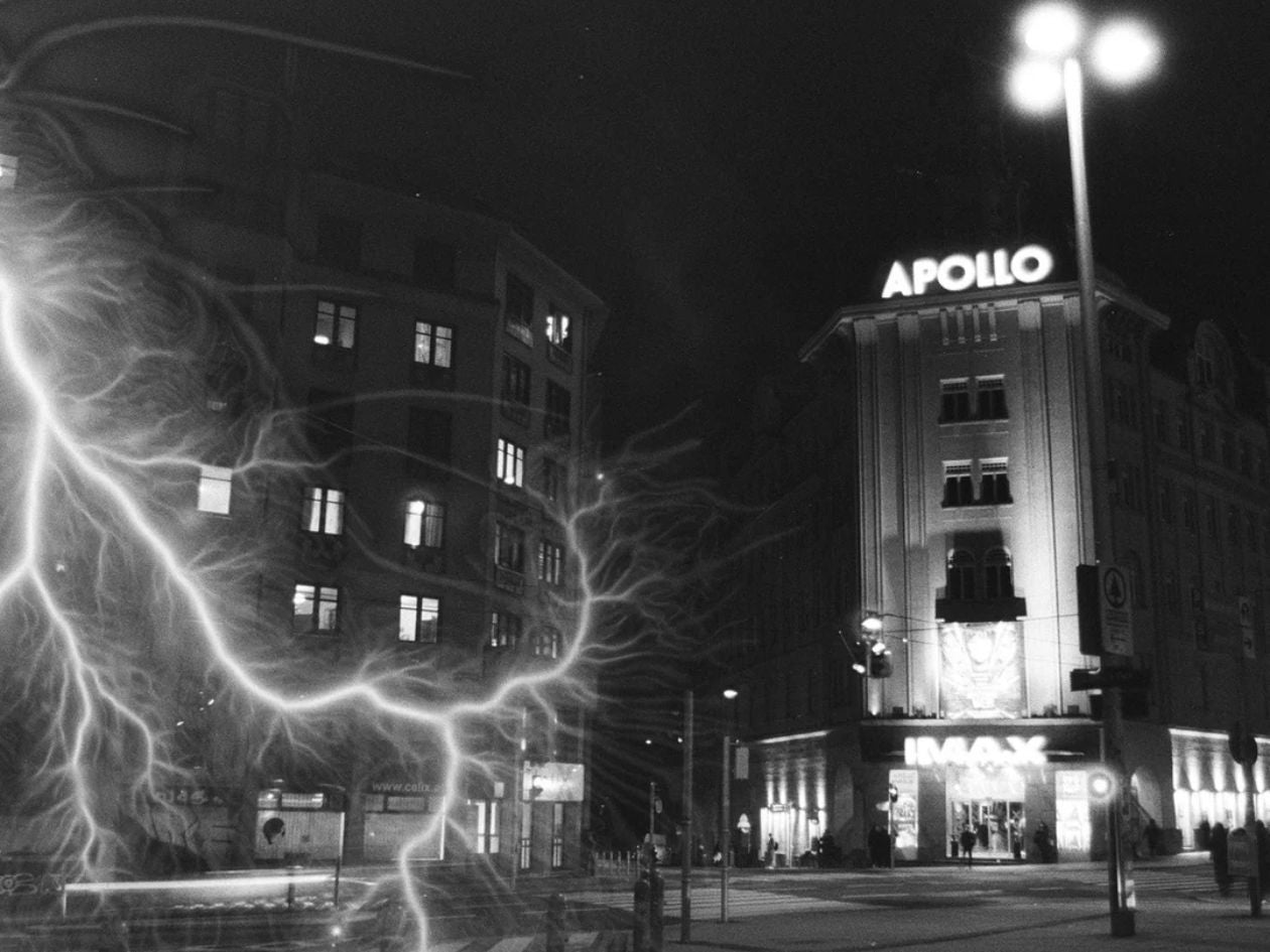 A nighttime city scene featuring the illuminated Apollo IMAX building, intersected by glowing lightning effects.
