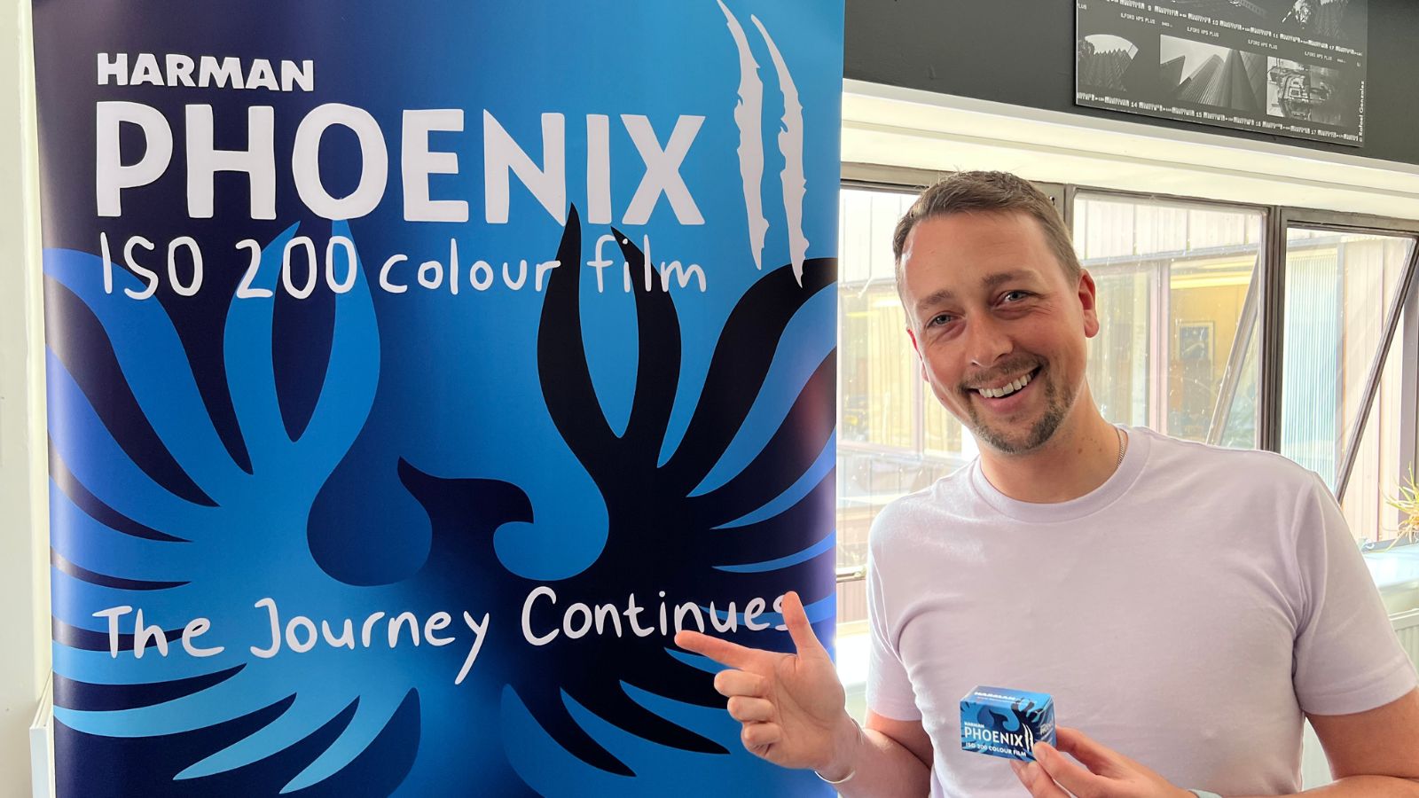 Paul McKay with a banner showing the launch of Harman Phoenix II colour film