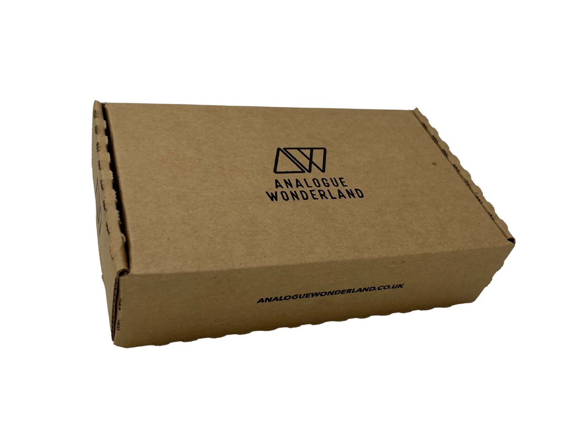 A brown corrugated cardboard shipping box with the black printed logo and text 'ANALOGUE WONDERLAND' on the top, shown on a plain white background.