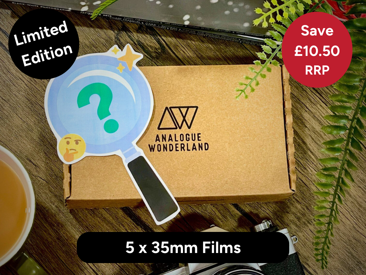 Brown box with 'Analogue Wonderland' logo featuring a magnifying glass with a question mark on a wooden surface.