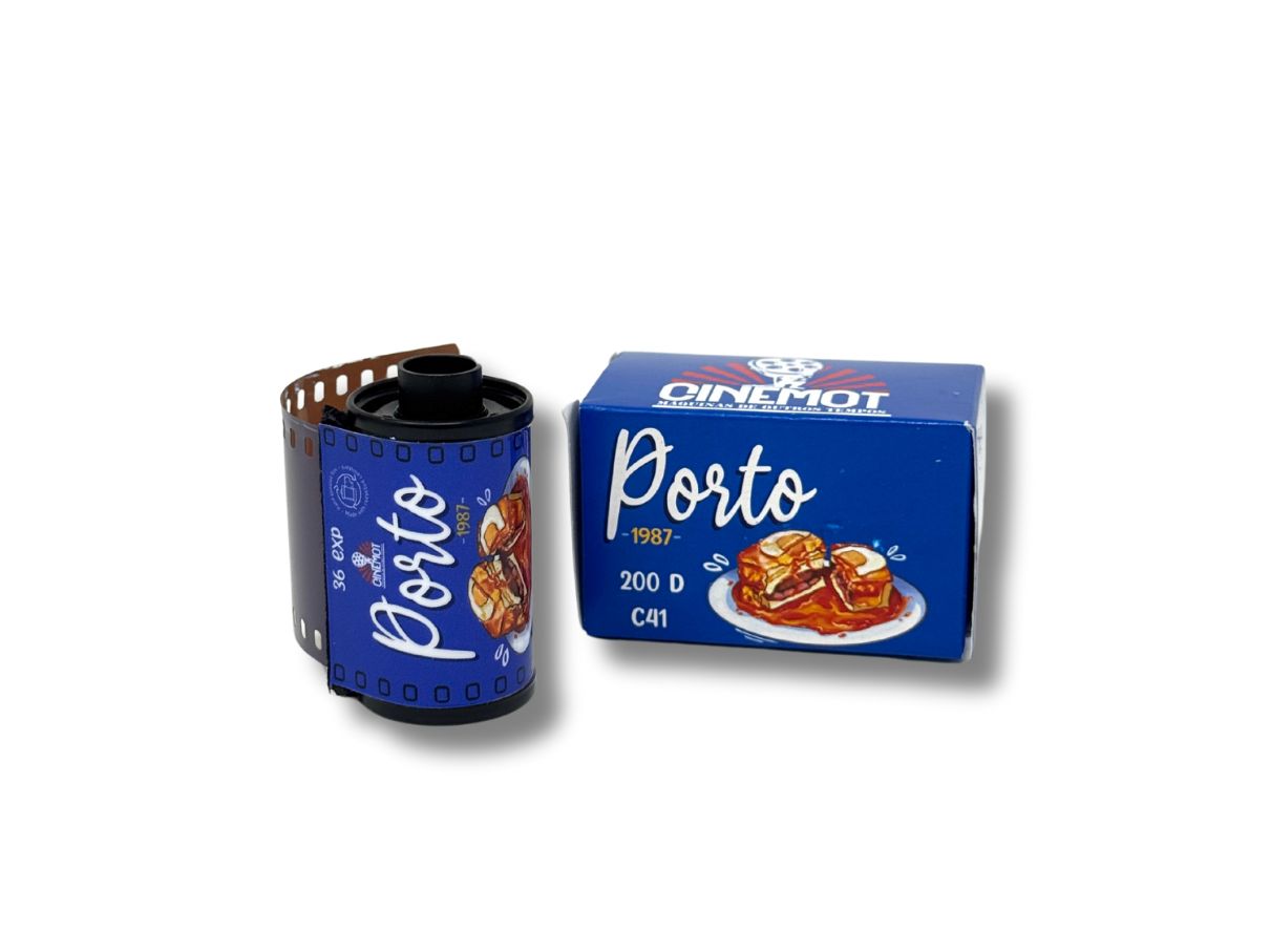 Blue box of Porto 35mm film on a white background with a plate of food showing a Portugese Francesinha sandwich, next to a single film cassette with the same branding.