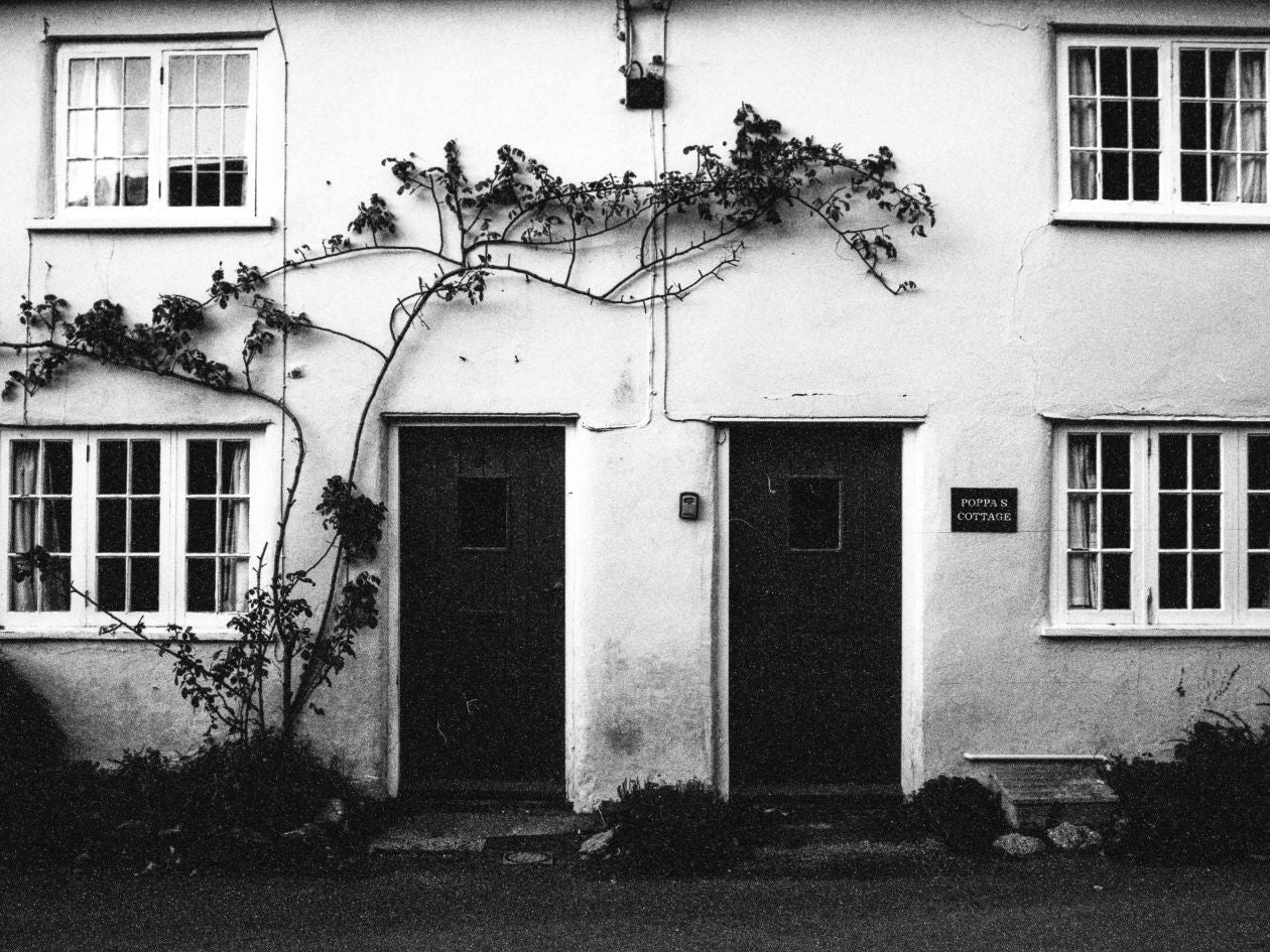 Black and white photo of a house with decorative elements.