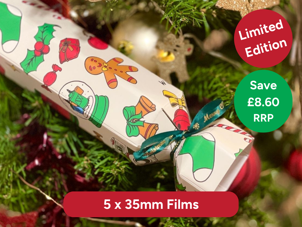 Christmas-themed gift box with festive design on a tree background. Limited Edition, 5 x 35mm films and Save £8.60 RRP