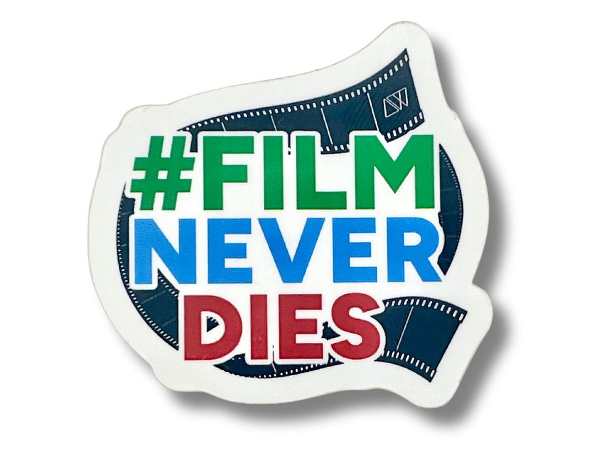 Sticker with '#Film Never Dies' text and Analogue Wonderland logo on a white background.