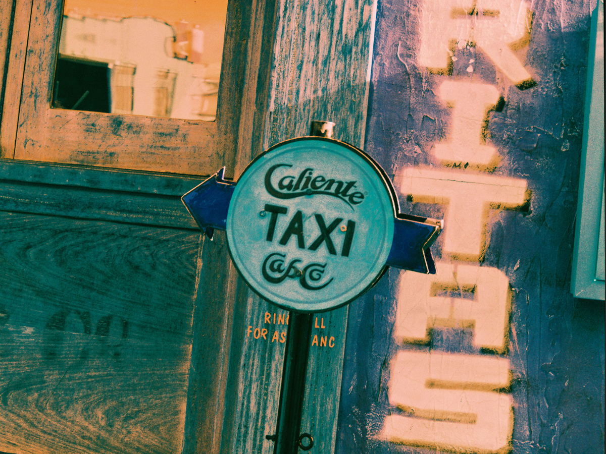 Sample shots (c) Sissi Lu. Vintage-style 'Caliente Taxi & Co.' sign on a textured surface