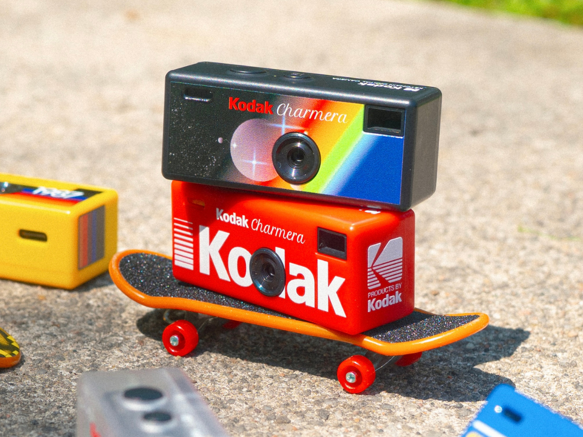 Kodak camera on a skateboard with a concrete background