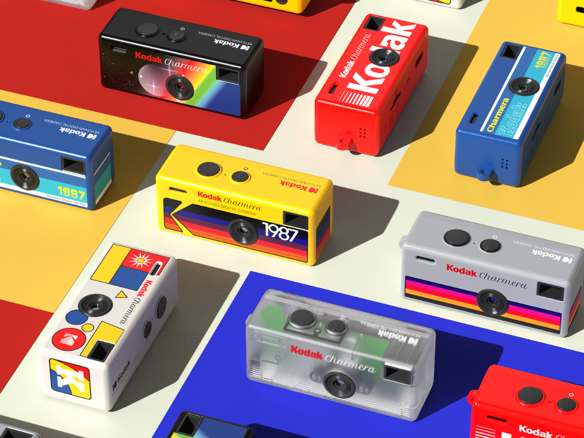 Collection of colorful Kodak Charmera Keychain cameras and cameras on a multicoloured background