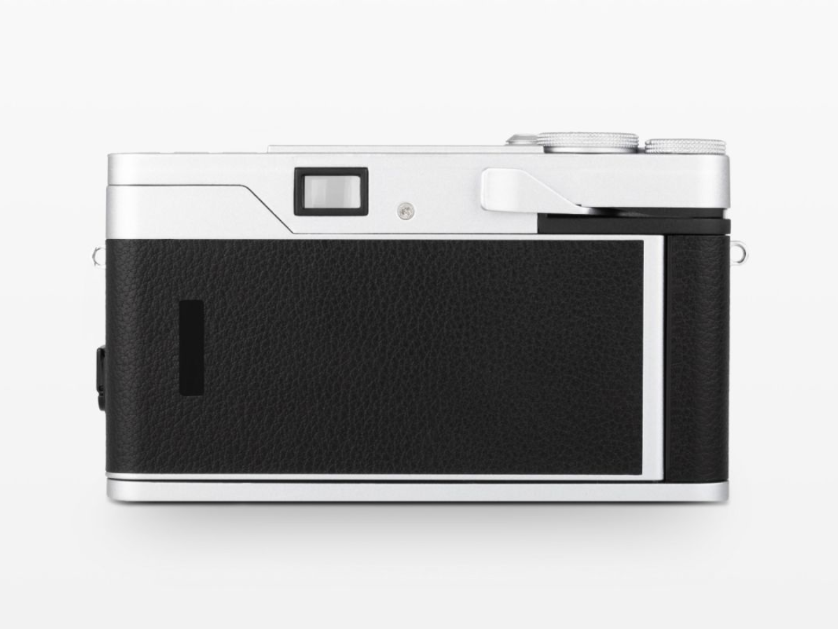 A Lomo MC-A camera shown from the back, featuring a textured black leather grip and a silver metal body, photographed on a seamless white background.