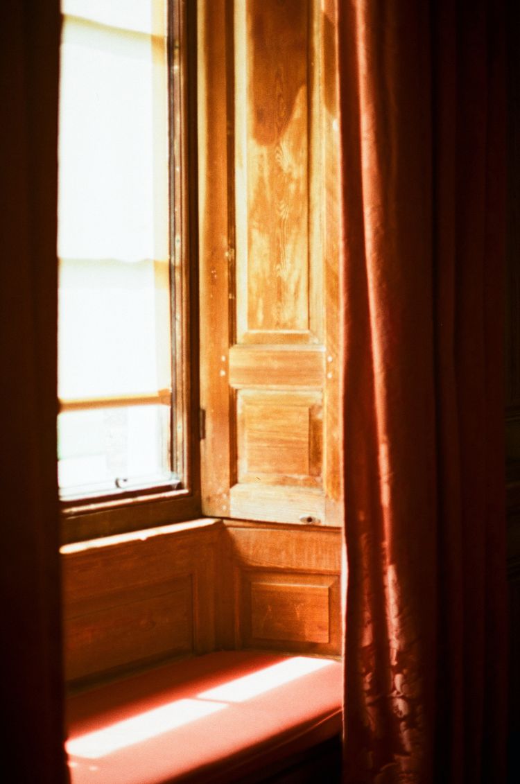 Sunlight streaming through a window with wooden shutters and a bench. Taken on Mr Negative Secret Sauce 35mm Film by Gary Smith.