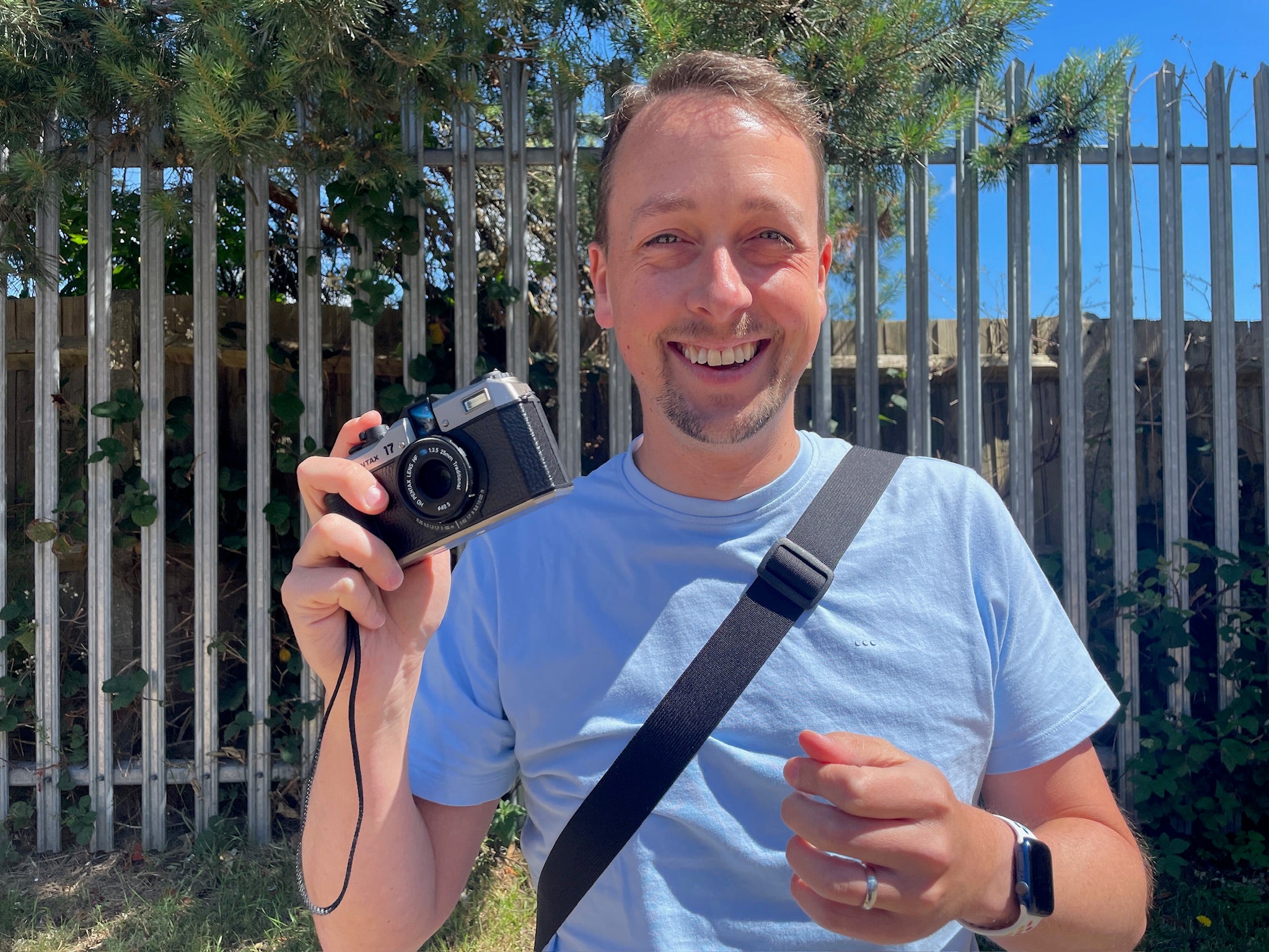 Paul McKay with his Pentax 17 film camera in hand - on a sunny day standing outside