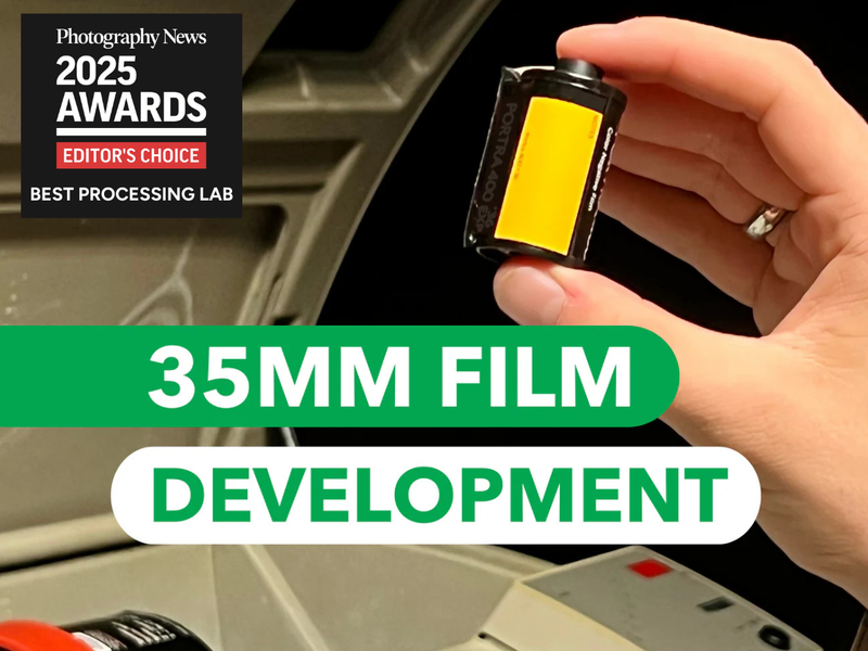 Hand holding a 35mm film canister with text about 35mm film development and an award badge.