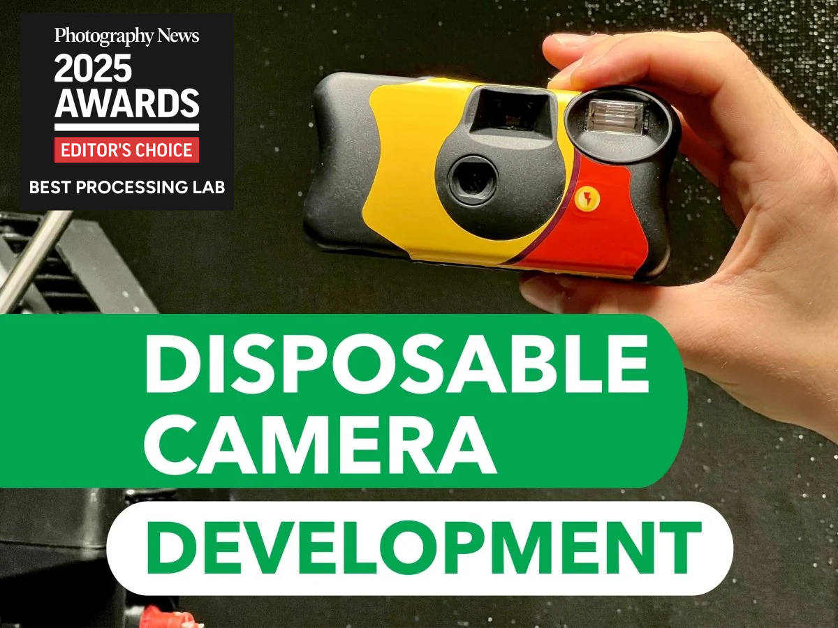 Disposable camera held by a hand with text about disposable camera development and Photography News awards.