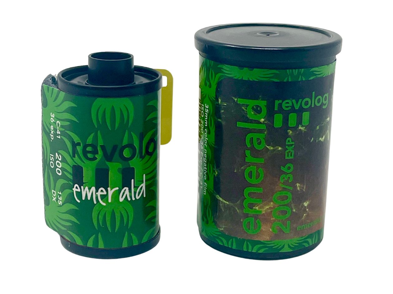 A green film cassette and plastic canister with 'revolog emerald' branding on a white background.